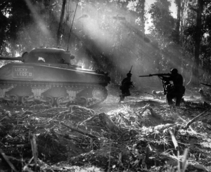 Infantrymen Find Cover Behind A Tank
